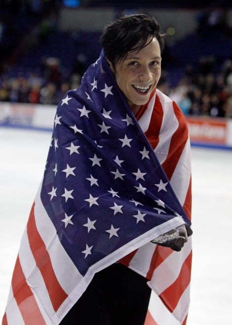 Third-place finisher Johnny Weir skates off with a U.S. flag after getting his medal in the men's free skate at the U.S. Figure Skating Championships in Spokane, Wash., Sunday, Jan. 17, 2010.