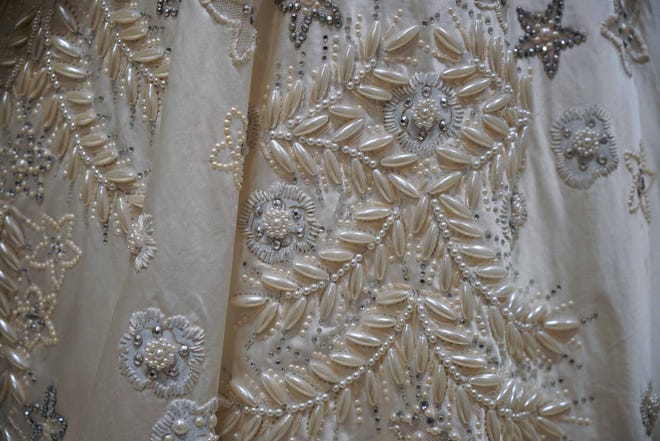 This detail of Queen Elizabeth's wedding dress in 'Costuming The Crown' at Winterthur Museum shows how designers use movie magic to combine printing and some beadwork on the bottom of the skirt, which wouldn't be seen in close-up. The top of the gown was much more lavishly embroidered.