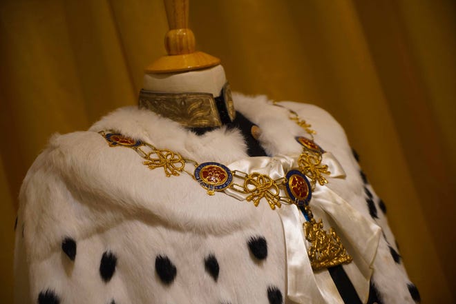 Prince Philip's red velvet robe topped with a white and black fur mantel is among the outfits from the television series 'The Crown' now on view at 'Costuming The Crown' at Winterthur Museum.