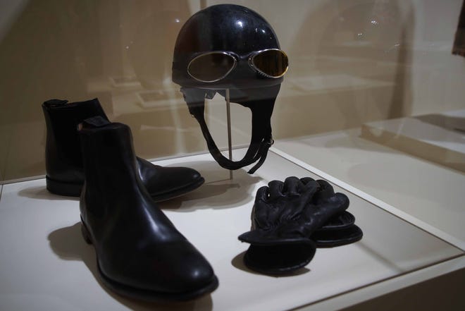 A man's motorcycle gear is among the clothing on display in Winterthur Museum's 'Costuming The Crown' exhibit, which features 40 outfits from the Netflix series.