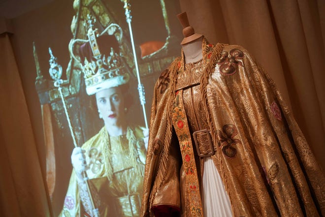The reproduction of Queen Elizabeth's gold coronation robe welcomes guests to "Costuming The Crown," Winterthur Museum's new exhibit featuring clothes from the hit Netflix show.