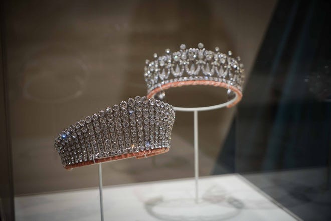 Two of the crowns from 'The Crown' television series are located near the gowns they were worn with in the 'Costuming The Crown' exhibit now at Winterthur Museum.