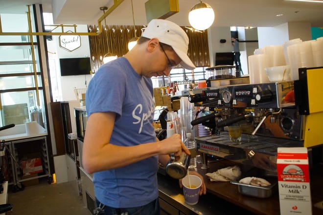 Quentin Cross, a manager for Spark'd, a pastry shop specializing in all-day baked goods, coffee and special-occasion cakes, at the Wilmington food hall known as DECO, test out the coffee machine during the final days before opening to the public.