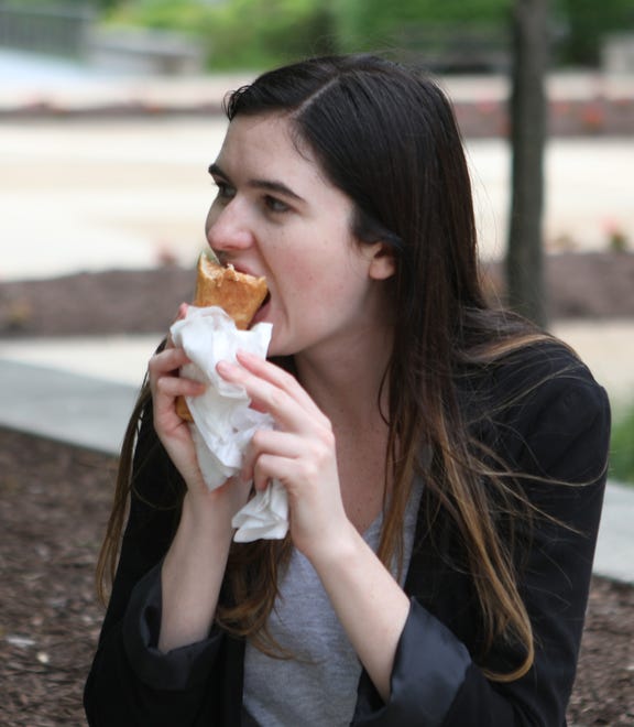 Jackie Mattson bites into a pizza cone at the Wilmington Riverfront.